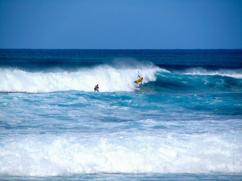 Surfers at Sunset Beach on Oahu's North Shore