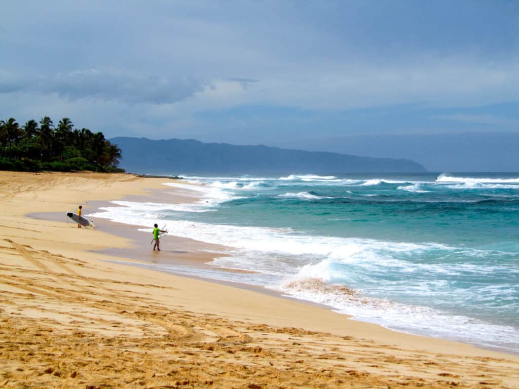 Surfers at Sunset Beach on Oahu's North Shore