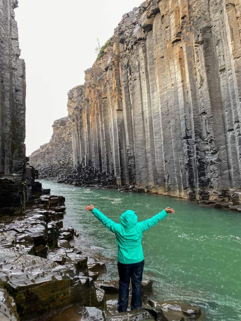 Amanda in rain gear at Studlagil Canyon