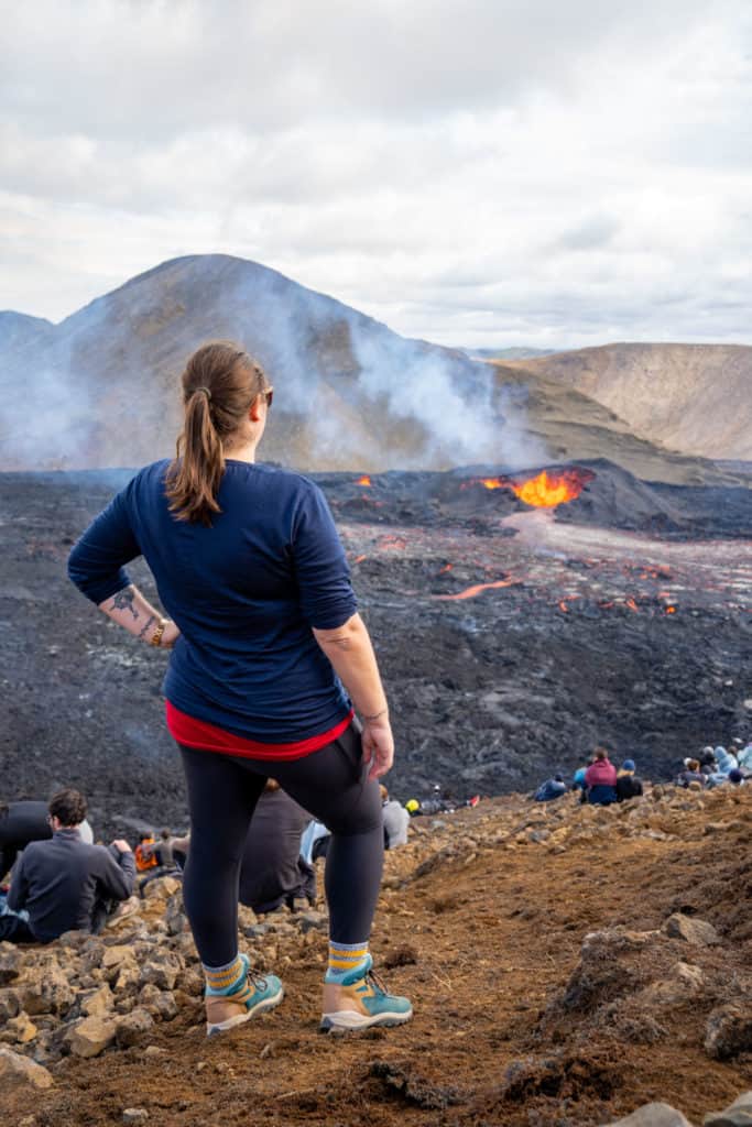 Amanda looking at an erupting volcano