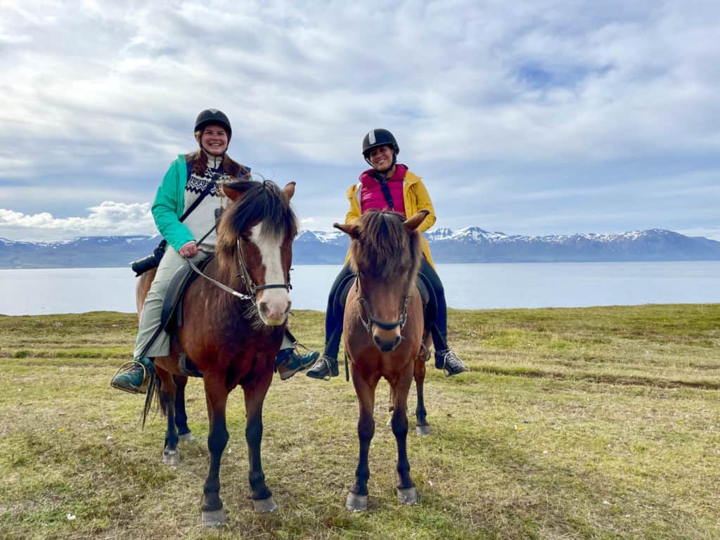 Amanda and Kate on Icelandic horses with mountains in the background