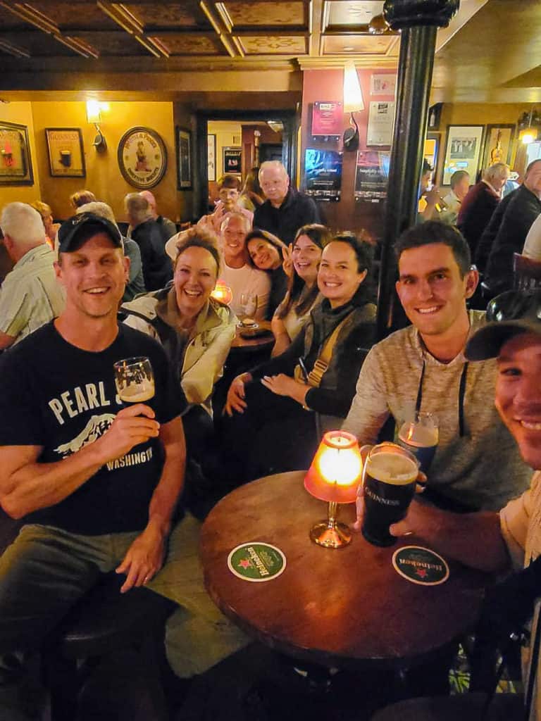 People gathered around a small table in a pub