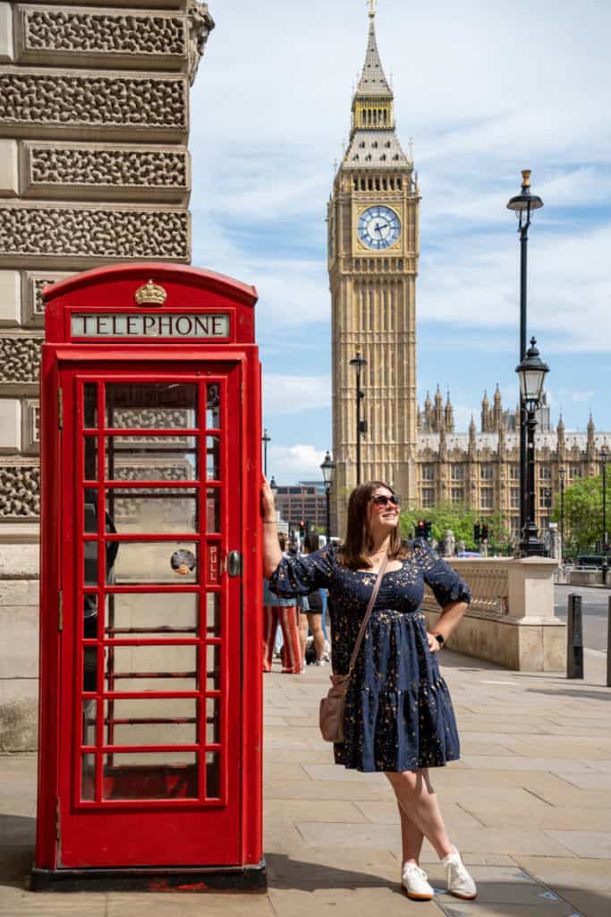 Amanda with a red phone box and Big Ben in London