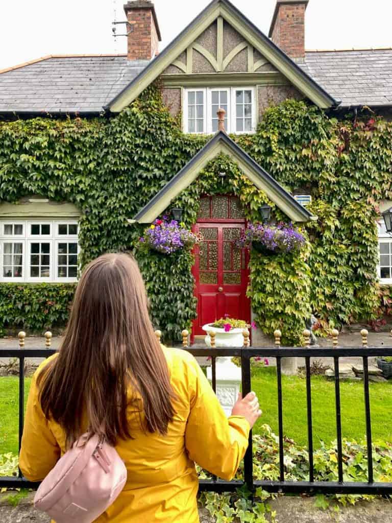 Amanda looking at an ivy-covererd house