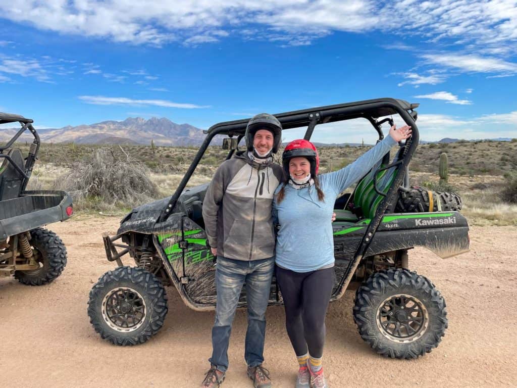 Amanda and Elliot posing in front of a UTV