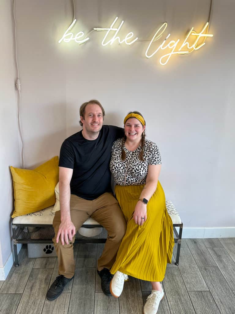 Amanda and Elliot sitting on a yellow bench