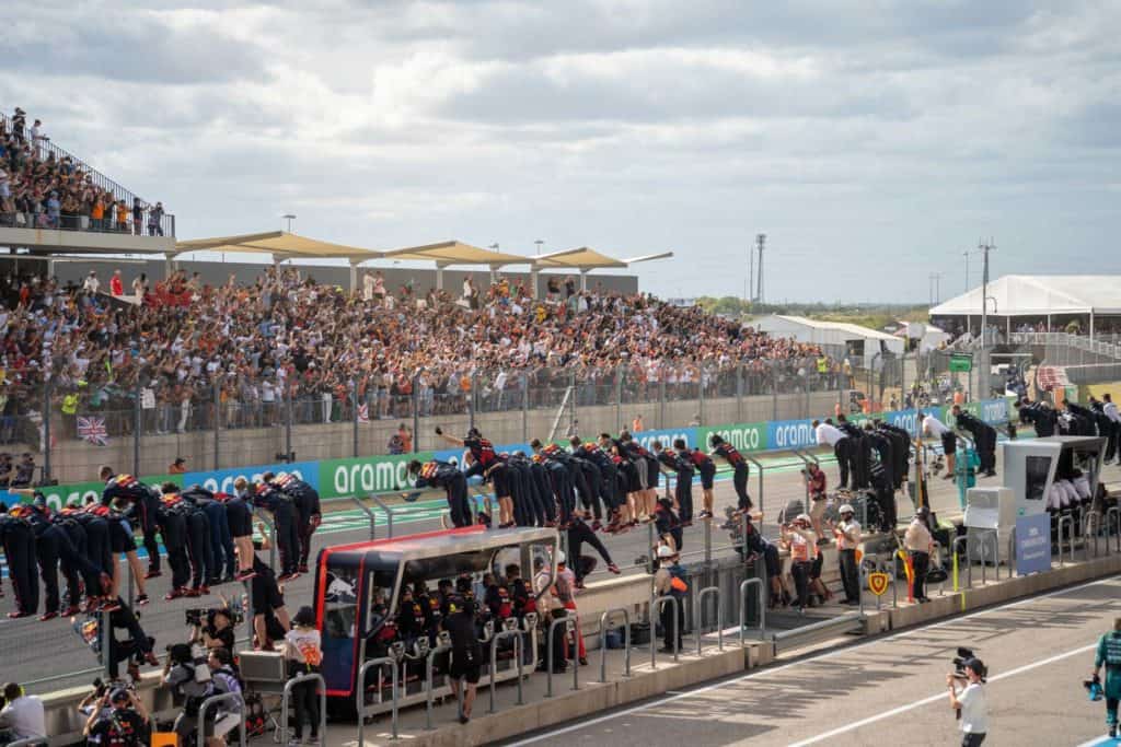 Pit lane crews climbing fences at COTA for end of the race