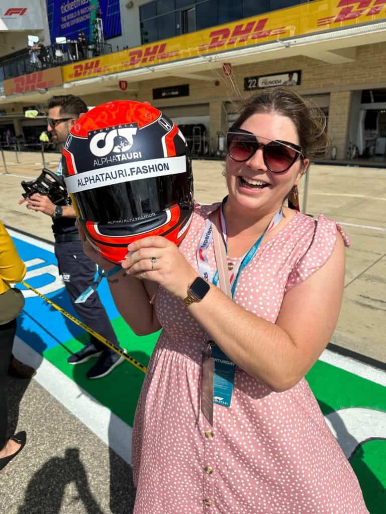 Amanda holding an AlphaTauri helmet