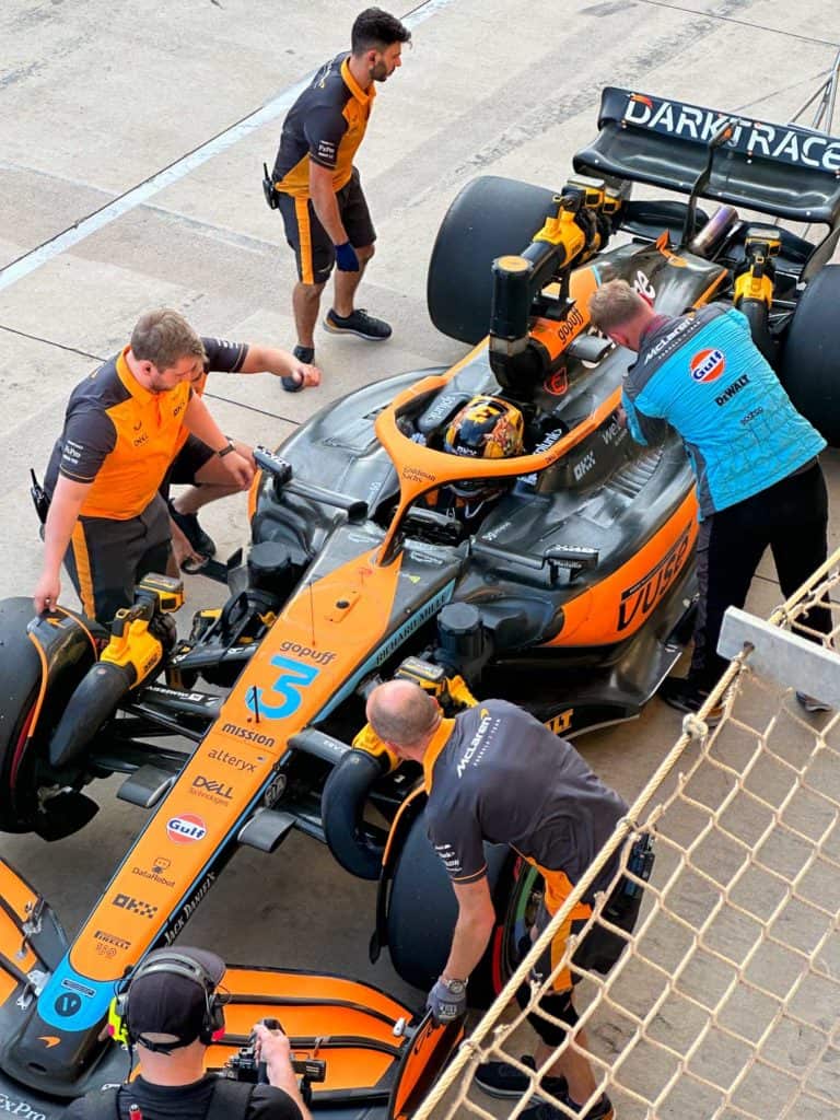 McLaren race car from above in the pit lane