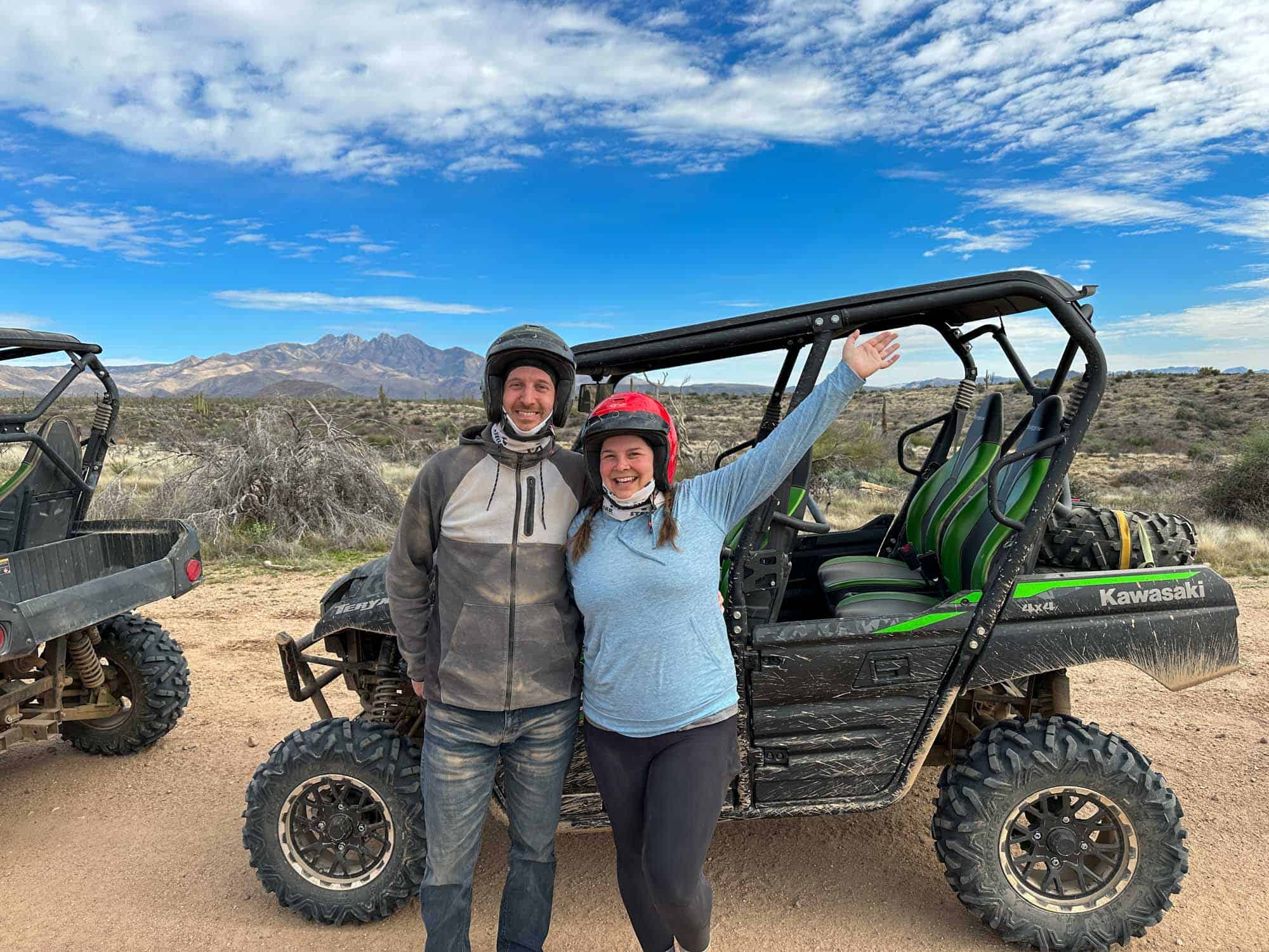 Amanda and Elliot posing in front of a UTV