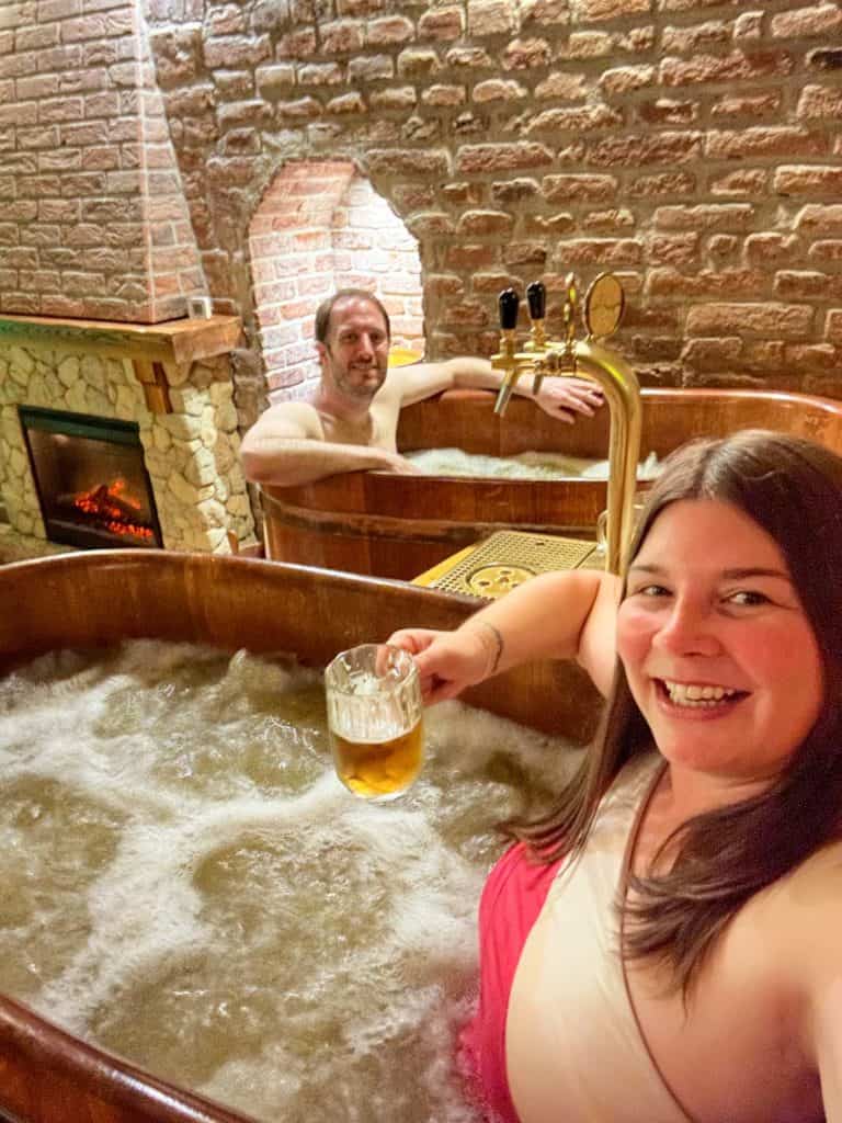 Amanda and Elliot in hot tubs at a beer spa